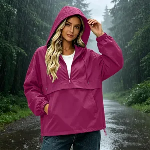 Detail view of the women's solid color waterproof hooded windbreaker featuring a half-zip design.