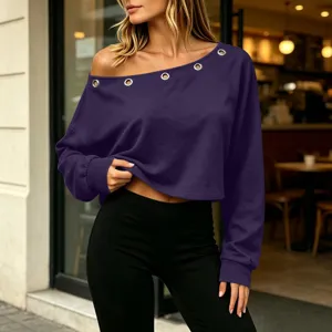 Detailed view of the women's solid color off-shoulder long sleeve top with metal eyelet details.