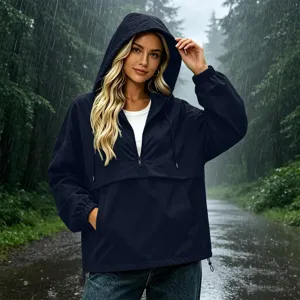 Rainy outdoor scene detail showing waterproof hooded windbreaker jacket with zipper and pockets.