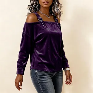 Purple velvet off-the-shoulder long sleeve top with strap details paired with blue jeans.