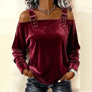 Close-up view of the velvet off-shoulder long sleeve top with decorative metal buckle straps.