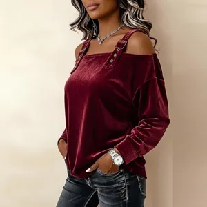 Burgundy velvet cold shoulder long sleeve top detail view, featuring chic strap and buckle.