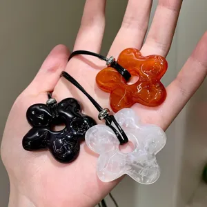Detail view of Korean style simple flower long necklace, hollow petal sweater chain accessories.