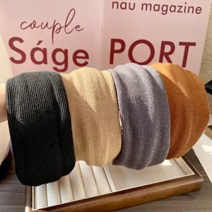 Knit wide headband detail display, showing black, beige, grey, and caramel colors well.