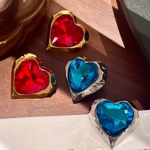 Vintage palace style heart crystal earrings detail showcasing red and blue faceted gems.