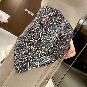 Black white paisley triangular scarf waist wrap skirt fashion layering accessory detail view.