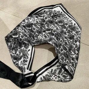 Black and white paisley pattern irregular triangular scarf, silky smooth fashion accessory for women.