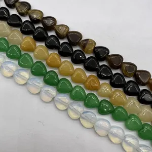 Detail view of colorful heart-shaped natural stone loose beads for DIY jewelry making crafts.
