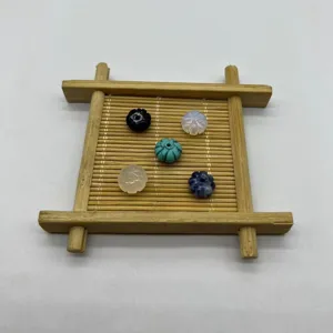 Detail view of natural stone carved pumpkin beads, perfect for handmade DIY jewelry making.