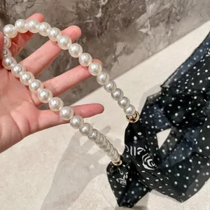Elegant white pearl chain black polka dot ribbon scarf, chic fashion neck accessory.