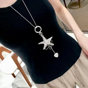 Close-up detail shot of the silver star pendant necklace, Y2K style fashion jewelry.
