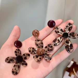Close-up detail of leopard print acrylic flower earrings, featuring unique resin floral design.