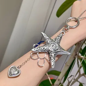 Close-up detail of the y2k cool style star and flower silver metal pendant accessory.