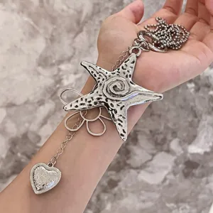 Detailed closeup view of the stylish Y2K silver star and flower charm necklace pendant.