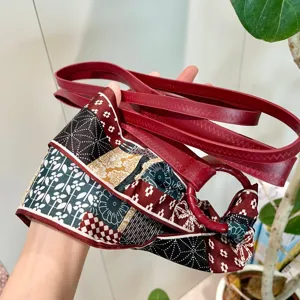 Vue detaillee de la ceinture en cuir rouge pour femme avec foulard imprime et anneau metal.