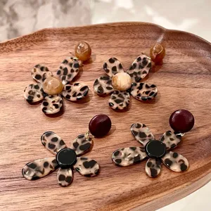 Leopard print flower earrings detail close-up showing resin material and unique acrylic design.