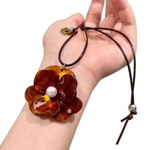 Brown flower pendant necklace for women, resin floral sweater chain with pearl and cord.