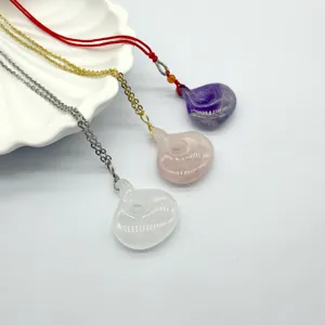 Natural crystal gemstone pendant detail, featuring rose quartz, amethyst, and white crystal.