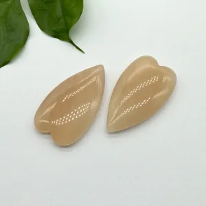 Detailed shot of natural crystal heart pendant stone, smooth polished finish for DIY jewelry crafting.