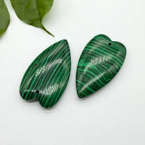 Green heart shaped stone pendant detail view, perfect for DIY jewelry making and crafting.