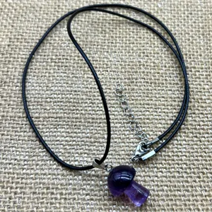 Natural crystal stone mini mushroom pendant necklace with black cord and metal extension chain.