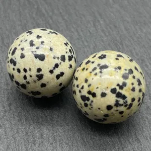 Detailed view of polished natural crystal spheres with unique spotted mineral patterns.