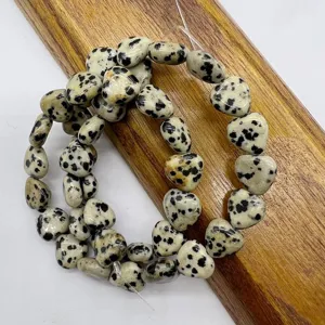 Detailed close-up view of natural stone heart-shaped loose beads, ideal for DIY jewelry making.