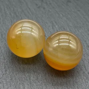 Detailed shot of 20mm natural crystal agate spheres, smooth polished stones for home decor.