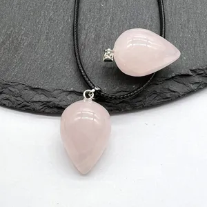 Close-up view of the natural pink quartz teardrop crystal pendant with delicate black cord.