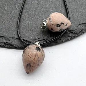 Detailed close-up of natural stone teardrop crystal pendant showing unique texture and patterns.