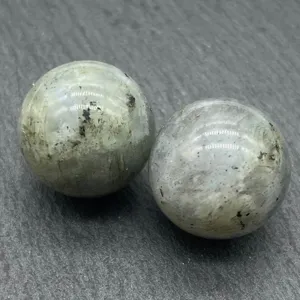 Close-up detail shot of polished natural crystal spheres displaying unique mineral texture and gloss.
