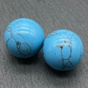 Detail shot of 20mm blue stone sphere with black veins, close-up texture display.