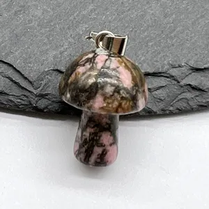 Natural stone carved mushroom pendant close-up view, crystal fashion jewelry.