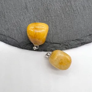 Natural yellow crystal tumbled stone pendant detail shot, polished gemstone charm for DIY necklace.
