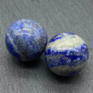 Close-up shot of natural lapis lazuli crystal spheres, showing unique blue and golden pyrite details.