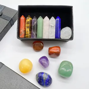 Detailed close-up view of natural crystal hexagonal pillars and tumbled stones set in a black gift box.
