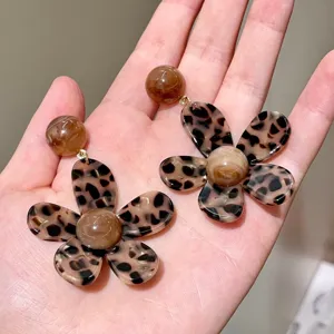Detail view of trendy leopard print flower earrings, showcasing unique resin texture and style.