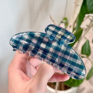 Blue plaid hair claw clip detail showcasing translucent resin material and strong metal spring.