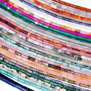 Close-up detail of colorful natural stone tube beads, multi-color DIY jewelry findings.