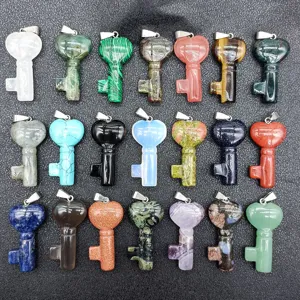 Detailed view of colorful natural crystal and agate heart key pendants for jewelry making.