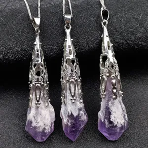 Detailed view of natural raw amethyst crystal point pendants with ornate silver caps.