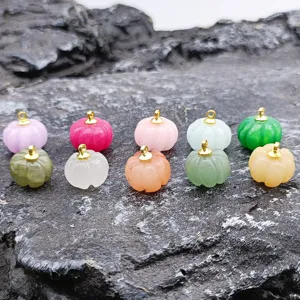 Close up of carved jade pumpkin pendant detail for DIY jewelry making and accessories