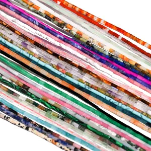 Closeup of colorful natural stone crystal tube beads, cylindrical gemstone loose bead strands.