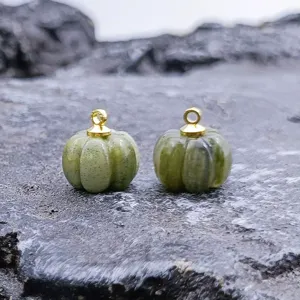 Detail view of the exquisite carved green jade pumpkin pendant, perfect for DIY jewelry making.