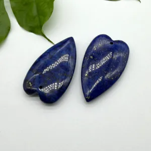Natural lapis lazuli heart shaped pendant detail view, polished gemstone DIY jewelry making material.