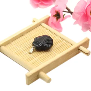 Black carved shell pendant semi-precious stone DIY jewelry accessory detail view.