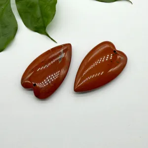 Natural red agate crystal heart-shaped pendant DIY jewelry making craft component closeup view.