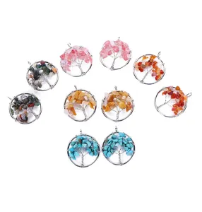 Detail view of handmade wire wrapped crystal tree of life pendants with colorful natural stone chips.