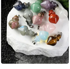 Natural stone crystal cone pendulum pendants detail closeup, colorful gemstone amulet charms.