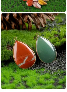Detailed view of teardrop crystal agate stone pendant with gold plated edge accessory.